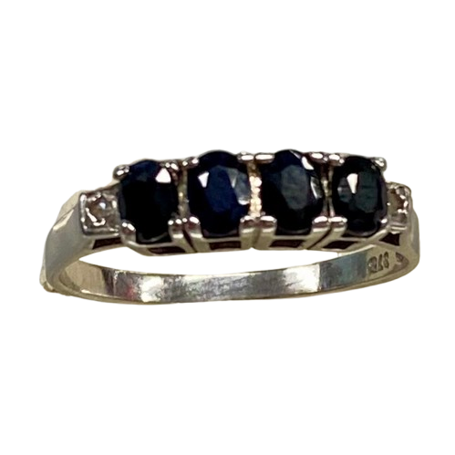 Ladies 9ct White Gold 6 Stone Sapphire & Diamond Ring. 4 Oval Sapphires, 4 Claw Set. With 2 Square Grain Set Diamonds In Swept Up Shoulders. TDW 1.15ct. Size P/8 . With Valuation Certificate – (NG 73254)