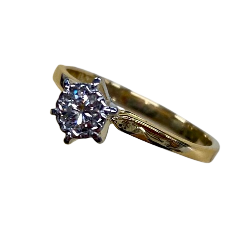 Ladies 18ct Yellow & White Gold Single Stone Diamond Ring. Round Brilliant Cut Diamond Illusion Grain Set With Tapered Gallery With Pointed Swept Up Shoulders. TDW 0.20ct. Size L/6, With Valuation Certificate (NG 142944)