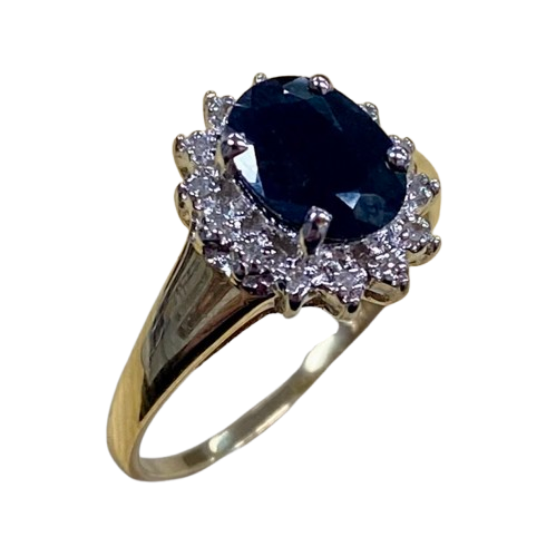 Ladies 9ct Yellow Gold 15 Stone Diamond & Sapphire Ring. Oval Sapphire In Rhodium 4 Claw Setting, Surrounded by 14 Single Cut Diamonds Illusion Bead Set in Rhodium Plated Basket, In Swept Up Shoulders. TDW 0.07ct. Size M/6.5, With Valuation Certificate – (NG 1307520)