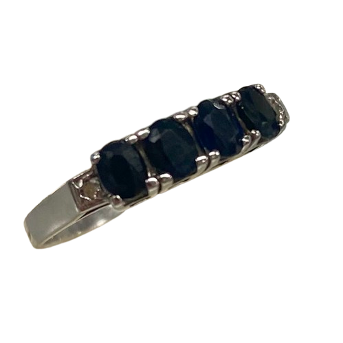 Ladies 9ct White Gold 6 Stone Sapphire & Diamond Ring. 4 Oval Sapphires, 4 Claw Set. With 2 Square Grain Set Diamonds In Swept Up Shoulders. TDW 1.15ct. Size P/8 . With Valuation Certificate – (NG 73254)