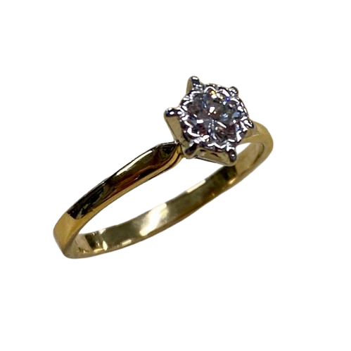 Ladies 18ct Yellow & White Gold Single Stone Diamond Ring. Round Brilliant Cut Diamond Illusion Grain Set With Tapered Gallery With Pointed Swept Up Shoulders. TDW 0.20ct. Size L/6, With Valuation Certificate (NG 142944)
