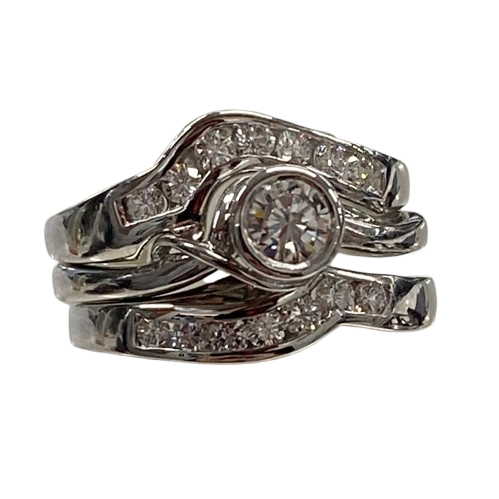 Ladies 18ct White Gold 3 Ring Set. Rub Over Set 0.30ct Round Brilliant Cut Diamond, With 7 Round Brilliant Cut Channel Set In Fitted Bands Each Side. TDW 0.72ct. Size O  With Valuation Certificate.