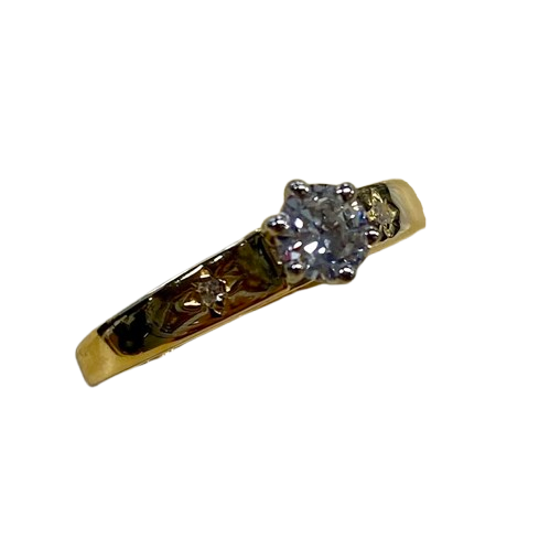 Ladies 18ct Yellow & White Gold 3 Stone Diamond Ring. Round Brilliant Cut 6 Claw Tapered Collet White Gold On A Yellow Gold Under Rail Diamond, With 2 Single Cut Diamonds Star Grain Set In Flat Top Swept Up Shoulders. TDW 0.32ct. Size N/7, With Valuation Certificate (NG 132482)