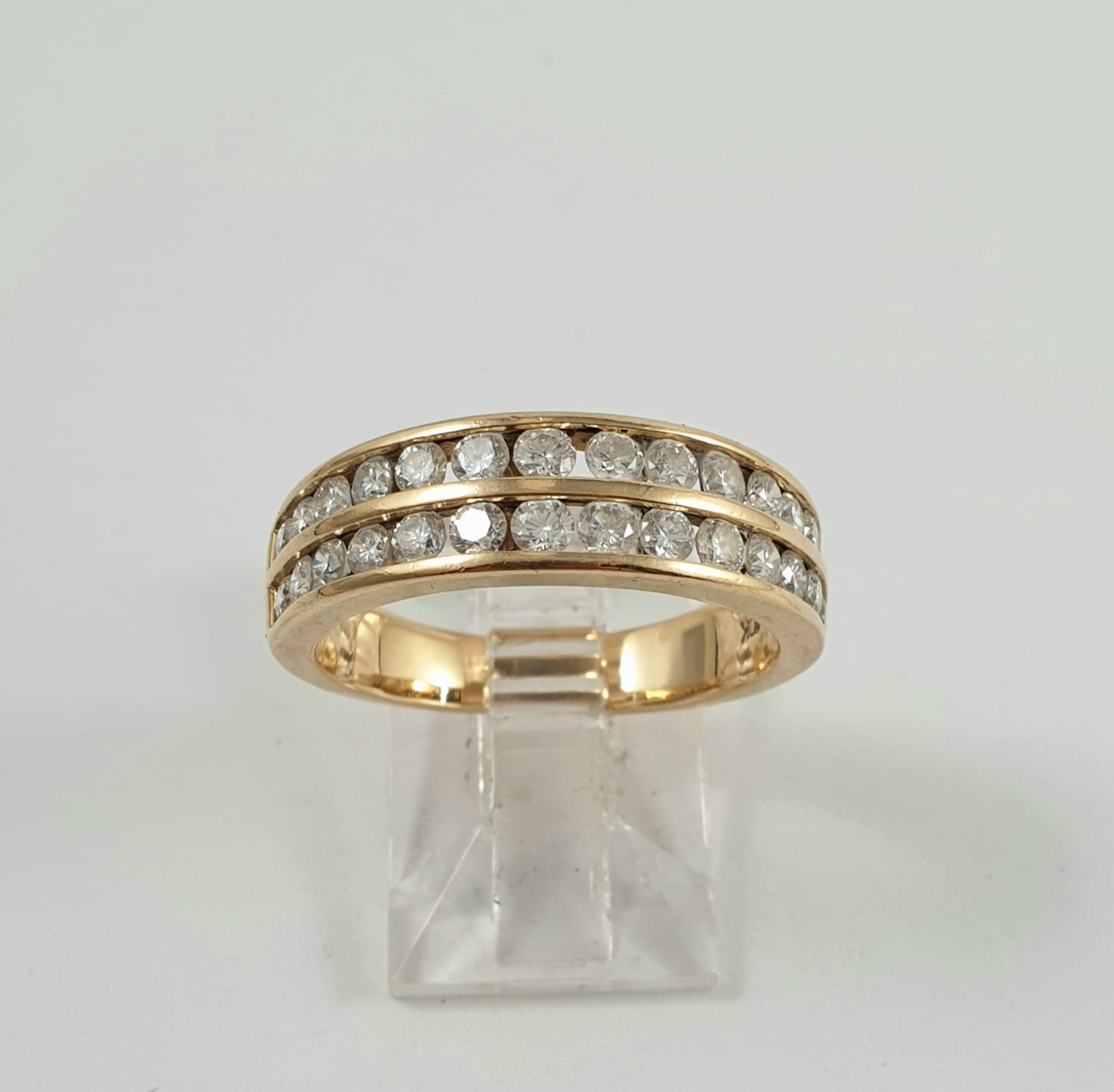 10CT GOLD RING CHANNEL SET WITH DIAMONDS TOTALLING 1.03CT