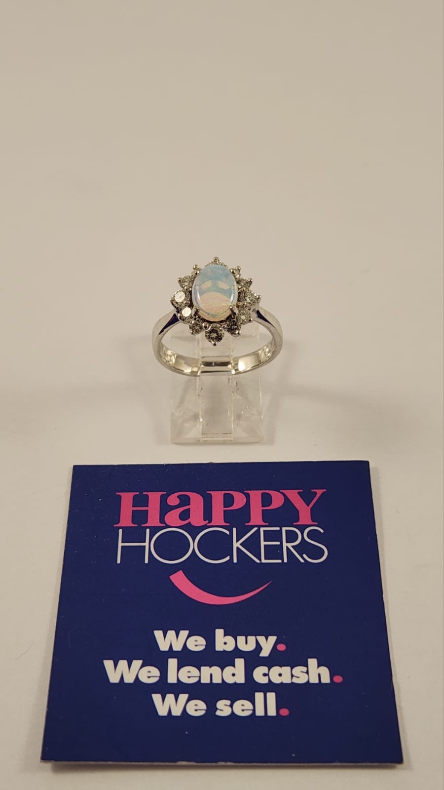 18CT WHITE GOLD RING SET WITH OPAL AND 12 X DIAMONDS TOTALLING 0.50CT. WEIGHT 3.6 GRAMS.