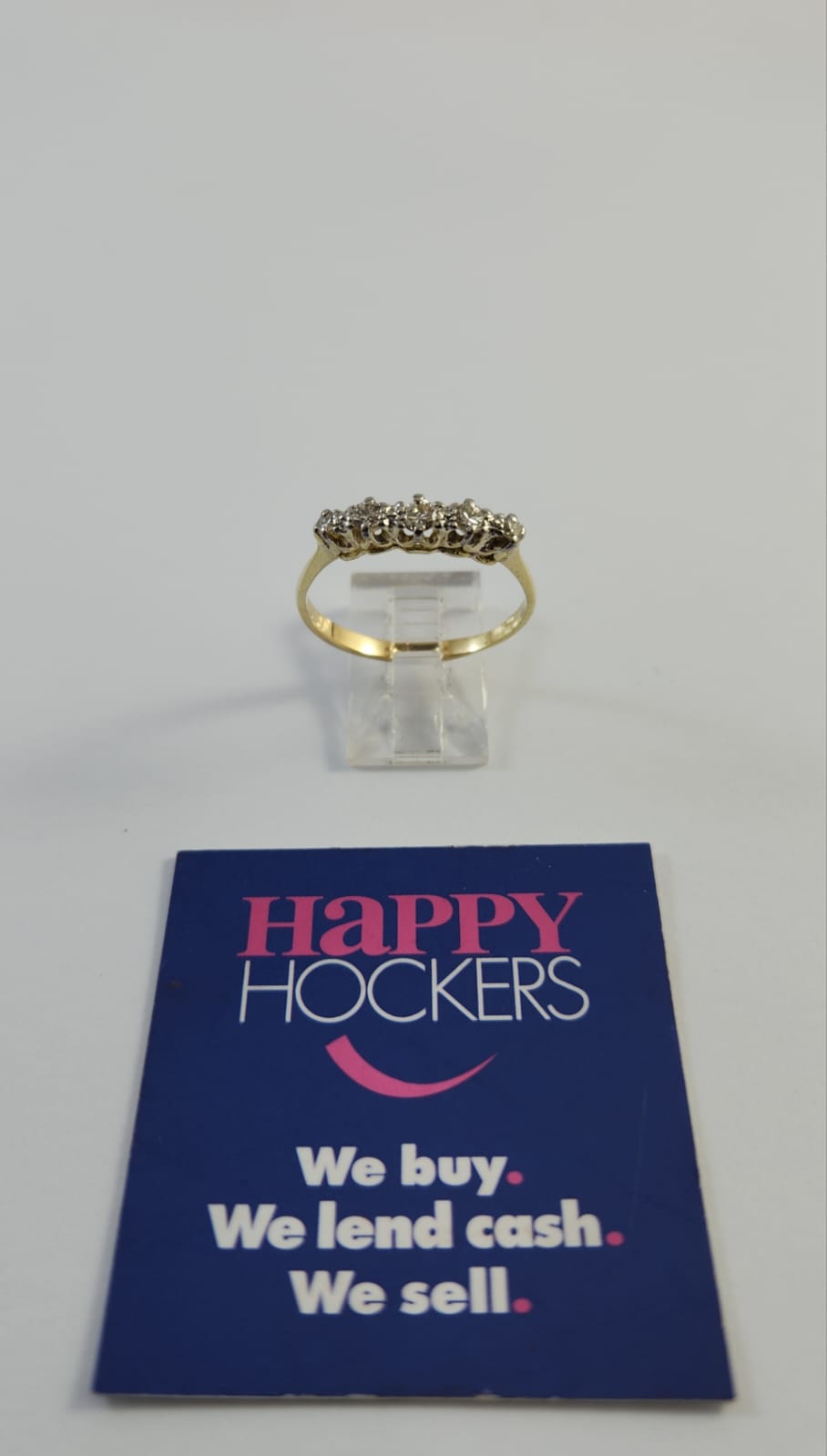 18CT YELLOW GOLD ETERNITY RING SET WITH 5 X DIAMONDS TOTALLING 0.35CT. WEIGHT 2.9 GRAMS. RING SIZE U. HALLMARKED 750