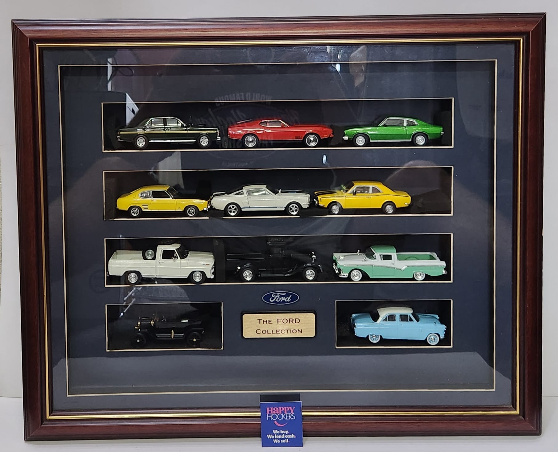 FORD CAR COLLECTION FRAMED MEMORABILIA PIECE. FEATURES 11 1:48 SCALE DIE-CAST METAL CARS