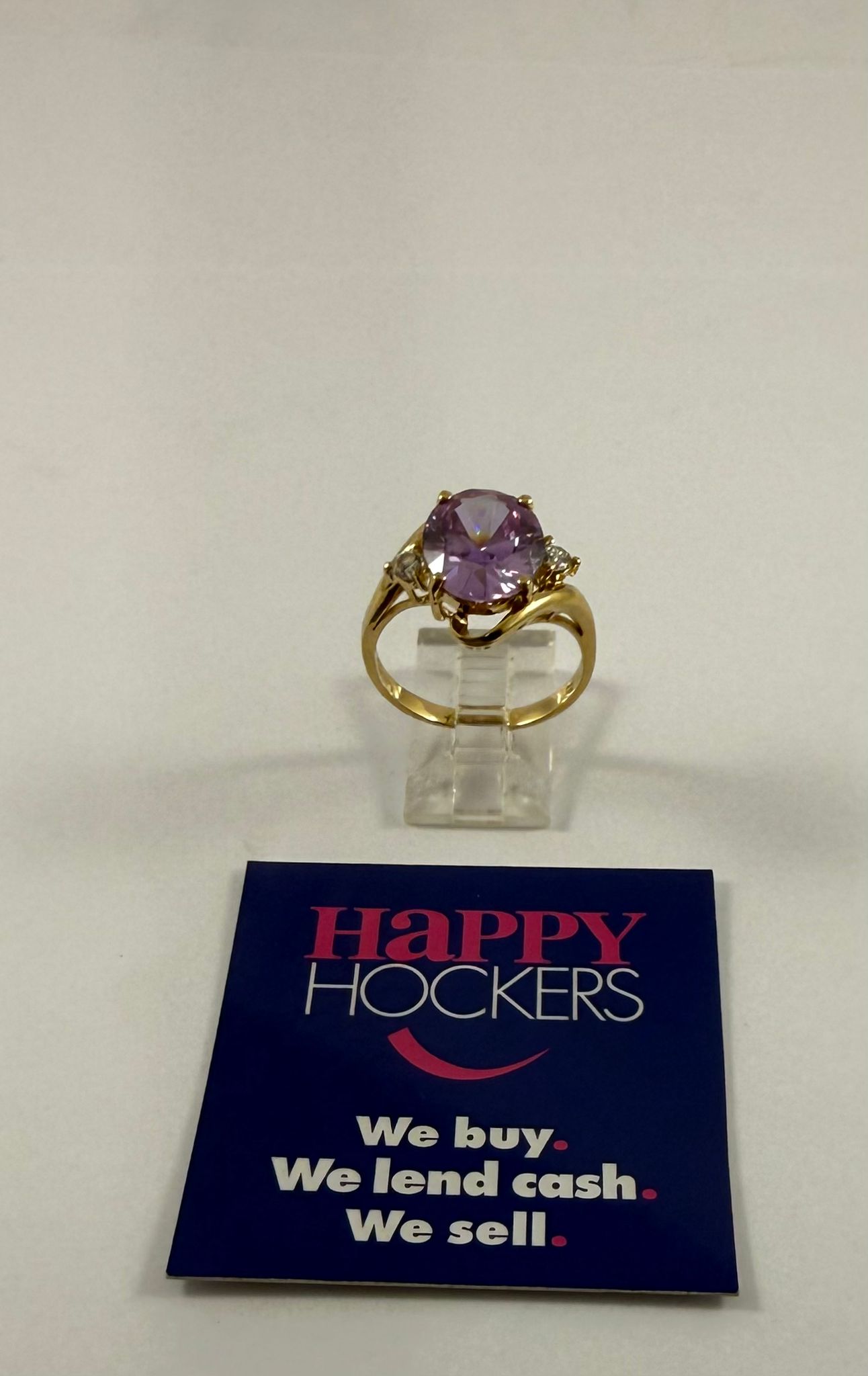 9CT YELLOW GOLD COCKTAIL RING WITH 1 PURPLE CUBIC ZIRCONIA AND 2 CLEAR CUBIC ZIRCONIA